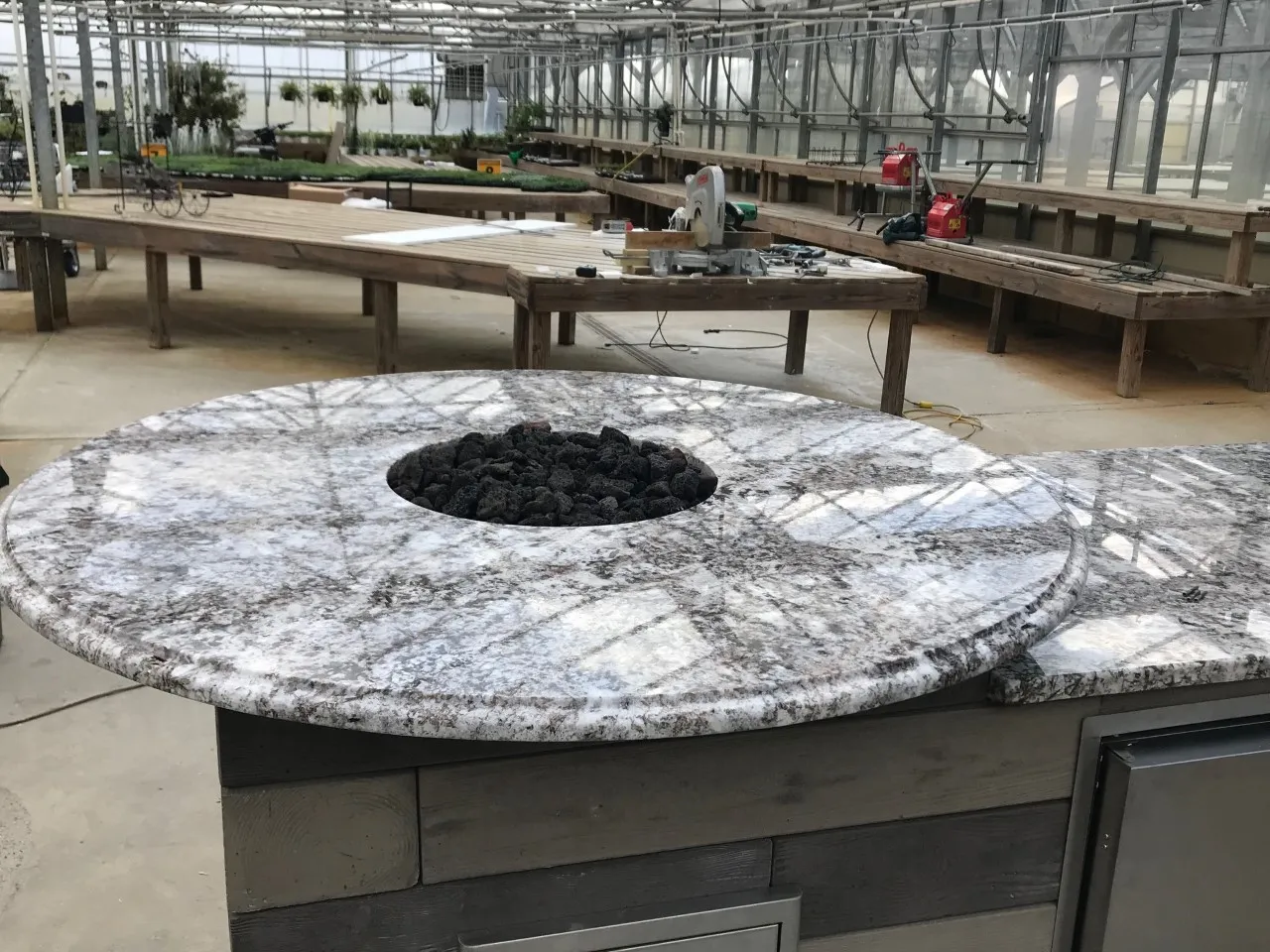 Round granite fire table by Ana Stone