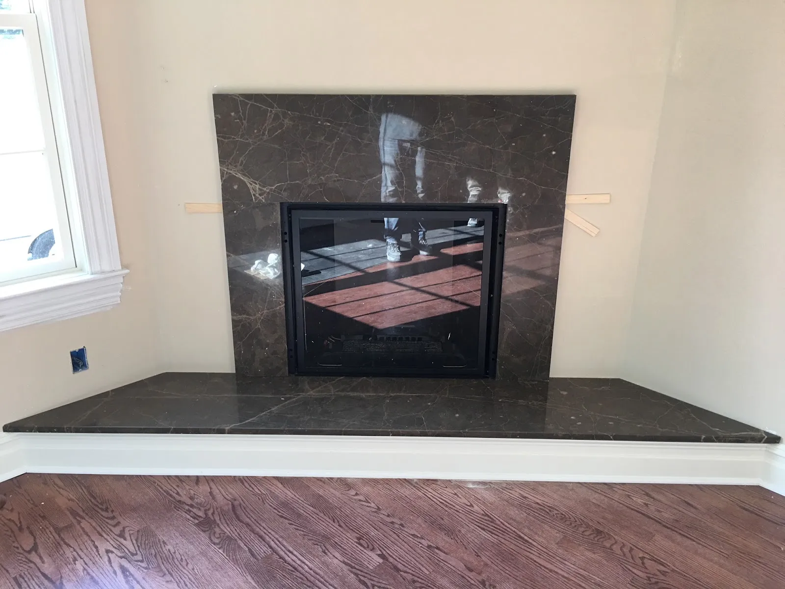 Fireplace surround by Ana Stone